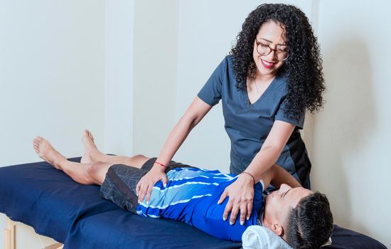 Female doctor with patient undergoing back treatment, Back rehabilitation physiotherapy,