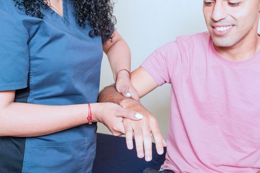 Physiotherapist with patient wrist assessment, wrist rehabilitation physiotherapy, hand wrist assessment