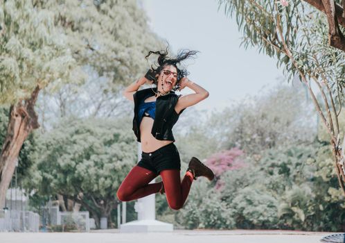 Happy urban girl jumping and listening to music, Girl jumping in the street and listening to music, Lifestyle girl listening to music, Woman jumping and enjoying music