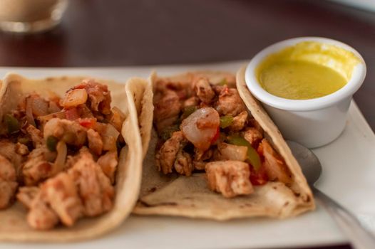 Close up of mexican chicken tacos, chicken tacos with salsa served on the table, tacos served on the table