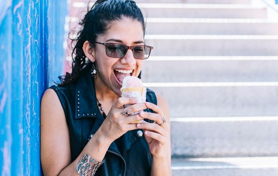 Urban girl eating an ice cream cone, A girl eating an ice cream outdoors, girl enjoying an ice cream, close up of a woman holding an ice cream