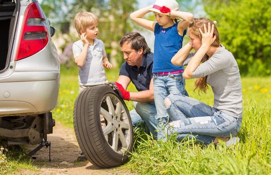 friendly family changes the tyre of the car