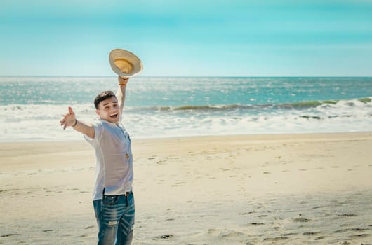 Happy handsome man on vacation outdoors, Happy latin young man on the beach, Tourist travel concept