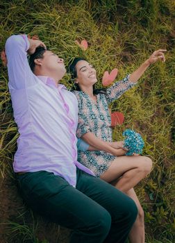 Wedding couple lying on the grass, couple lying on the grass, love concept