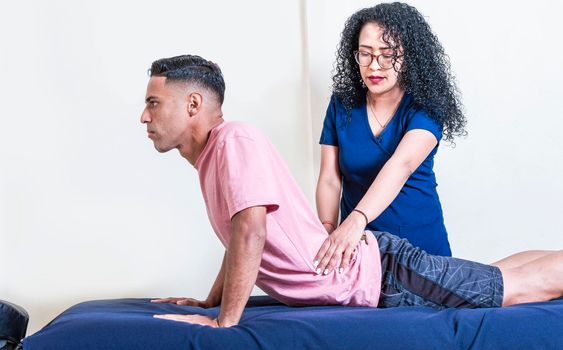 Lower back physiotherapy, physiotherapy treatment concept, physiotherapist with patient