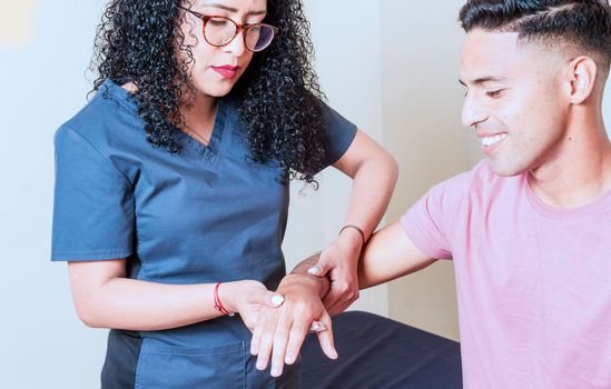 Physiotherapist with patient wrist assessment, wrist rehabilitation physiotherapy, hand wrist assessment