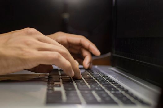 Hands on laptop keyboard, close up of hands on keyboard