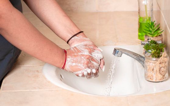 Close up of a person washing their hands with soap, concept of correct hand washing, ways to prevent covid19