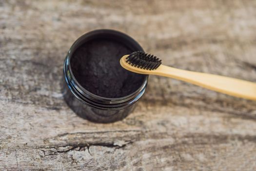 Activated charcoal powder for brushing and whitening teeth. Bamboo eco brush.