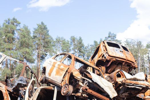 war in ukraine. Car graveyard. Shot cars of civilians. russia's war against Ukraine. Burnt and blown up car. Cars damaged after shelling. irpin bucha. war crimes.