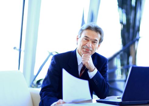businessman working in office, sitting at desk