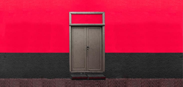 wooden door on red wall, door details on colored wall