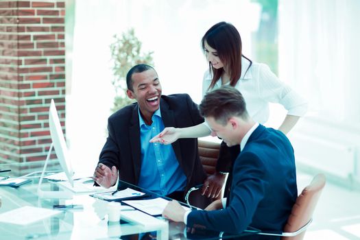 smiling business team talking ,sitting at their Desk in the office