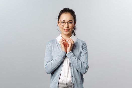 Lifestyle, people and emotions concept. Have great idea. Portrait of excited, pleased smart asian woman think-up plan, steeple fingers and smirk like genius, scheming something in mind.