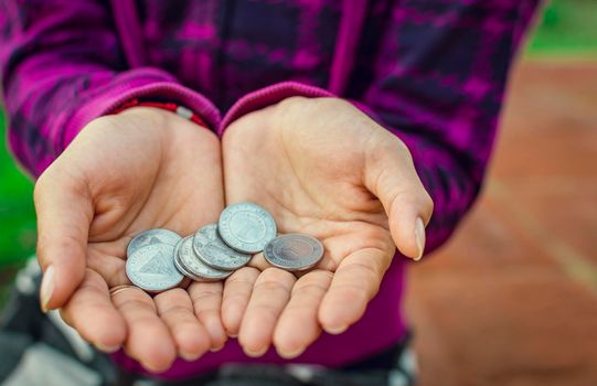 Close up of coins in hands, Nicaraguan coins in hands, savings concept