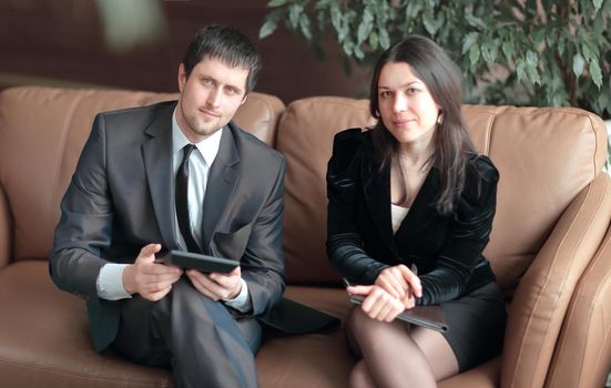 young businessmen discuss business document sitting on the couch in the business center.photo with copy space