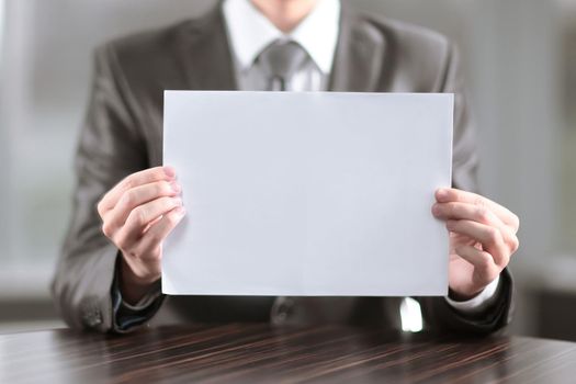close up.businessman showing blank sheet of paper.