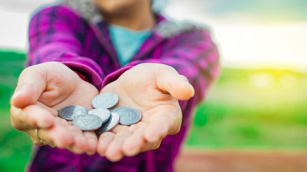Close up of coins in hands, Nicaraguan coins in hands, savings concept