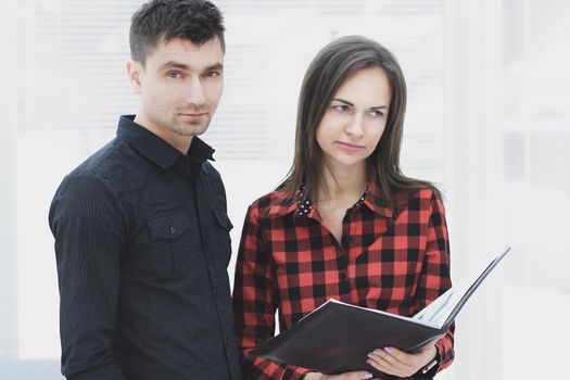 business couple with clipboard discussing working issues.