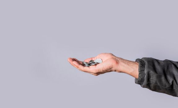 Hands with several coins in isolated background, Close up of hand with several coins, currency savings concept