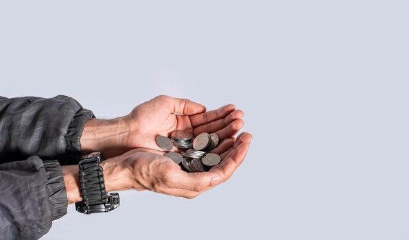 Hands with several coins in isolated background, Close up of hand with several coins, currency savings concept