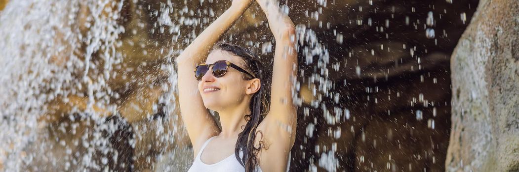 Young joyful woman under the water stream, pool, day spa, hot springs. BANNER, LONG FORMAT