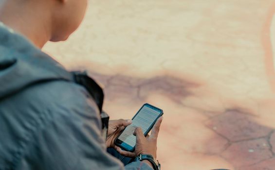 Close up of a man with cell phone in hand, close up shot of a person checking his cell phone, young guy with cell phone in hand with copy space