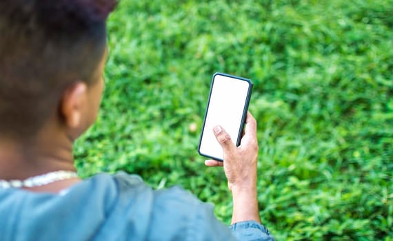 Close up of a man with cell phone in hand, close up of hands with cell phone with white screen, young guy with cell phone in hand with copy space