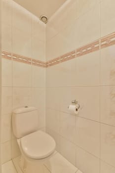 Interior of narrow restroom with sink and wall hung toilet with white walls and checkered floor