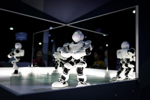 White robot on servos at the exhibition stand. Almaty, Kazakhstan - February 19, 2022