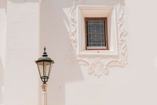 Lantern poles with copy space, an illuminated lantern pole next to a window, public lantern pole