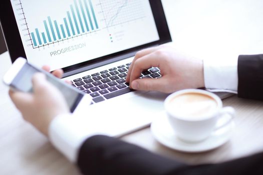 closeup. businessman sitting at a Desk during working hours.people and technology