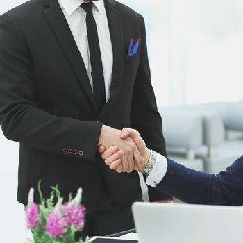 handshake of two business people near the table in the office.photo with copy space.