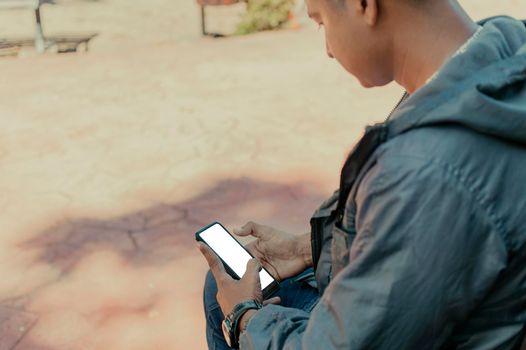 Close up of a man with cell phone in hand, close up shot of a person checking his cell phone, young guy with cell phone in hand with copy space