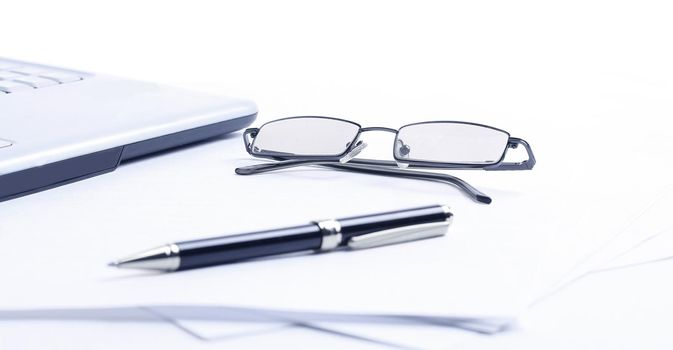 notebook ,glasses and pen on the workplace of the businessman .isolated on a white