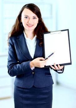Portrait of a cute young business woman with the work plan smiling.