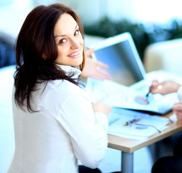 Business lady with positive look and cheerful smile posing for the camera