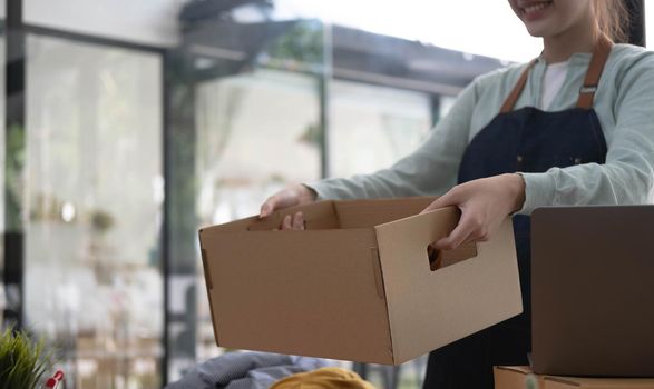 Starting small businesses SME owners female entrepreneurs Write the address on receipt box and check online orders to prepare to pack the boxes, sell to customers, sme business ideas online..