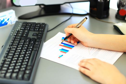 Business Woman Writing with pen in the office