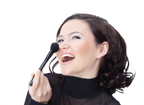 Beautiful woman with makeup brush near her face - isolated on white