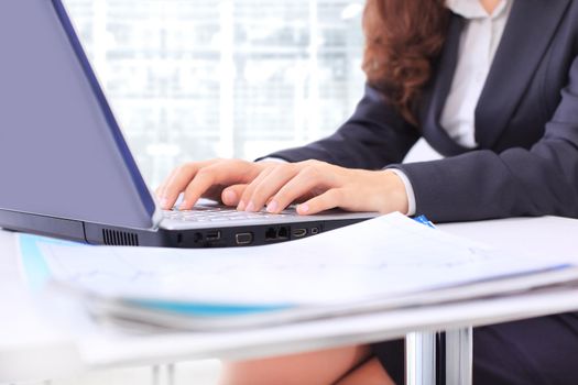 Business woman in the office, work at the computer, close-up.