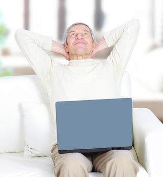 Adult male at home resting for a laptop.