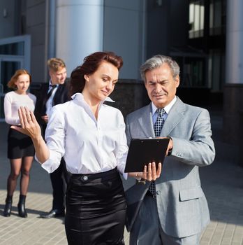 business colleagues talking about problems near the office