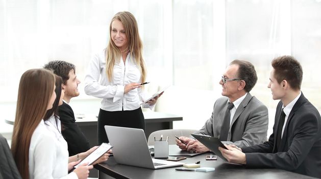 Businesswoman explaining business plan to her colleagues.photo with place for text