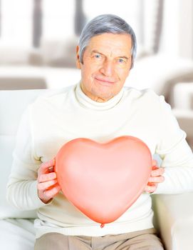 Male senior red heart isolated on white background.