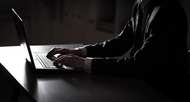 Person Typing on a modern laptop in an office