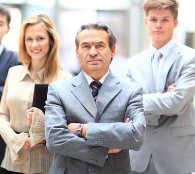 Happy smiling business team standing in a row at office