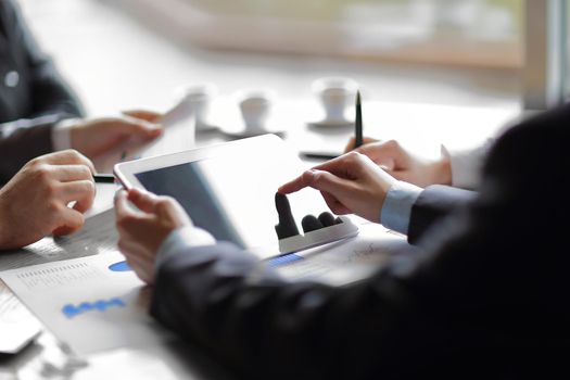 close up.the businessman uses a digital tablet for his work.people and technology