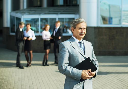 a successful businessman with documents on the background of the office