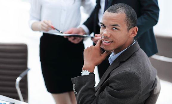 portrait of a young businessman on background of office.business concept